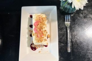 rhubarb & ginger cheesecake with a crumble topping and elderberry gel